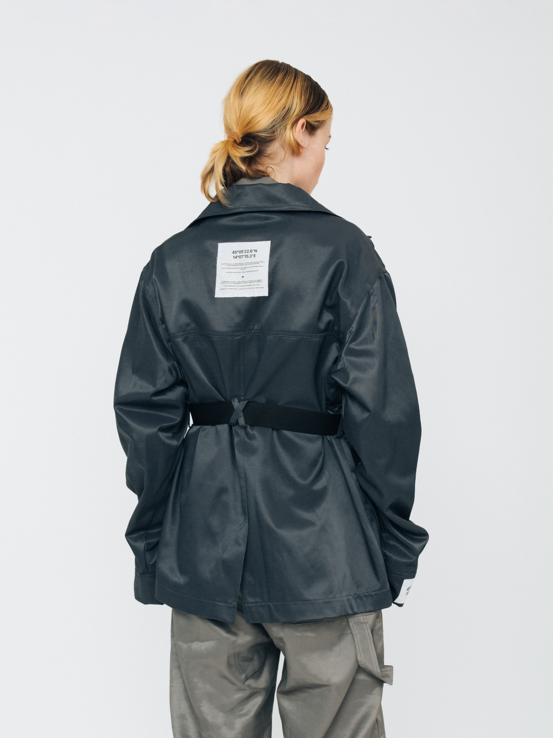 Female model wearing Kovari collection work jacket and jumpsuit