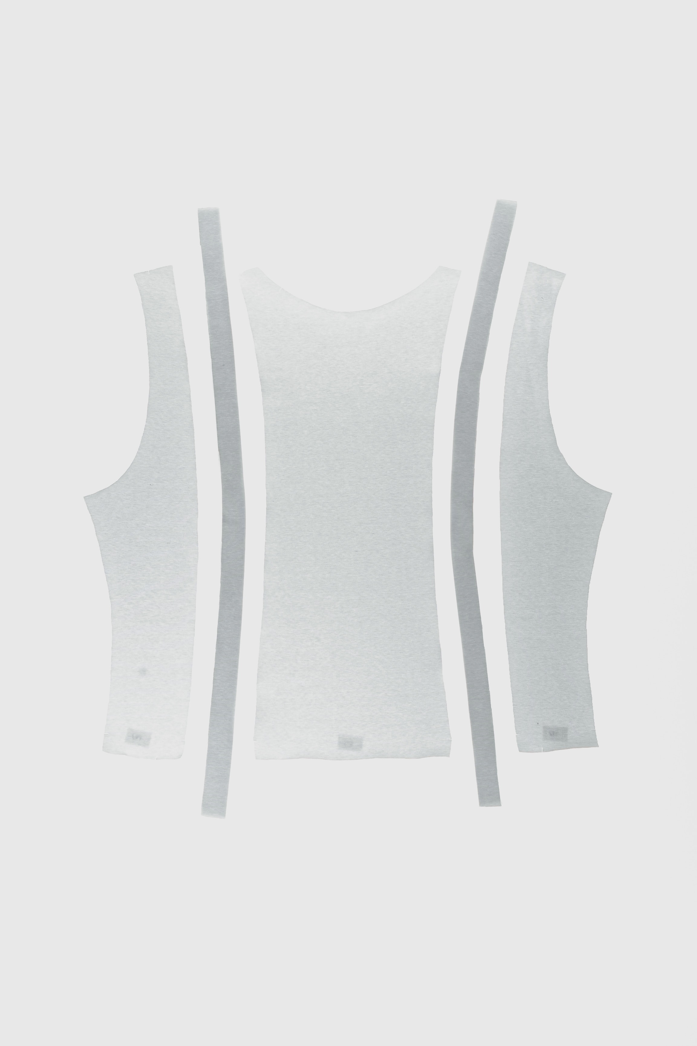 White knitted tank top pattern pieces showing tape finishing along the edges.