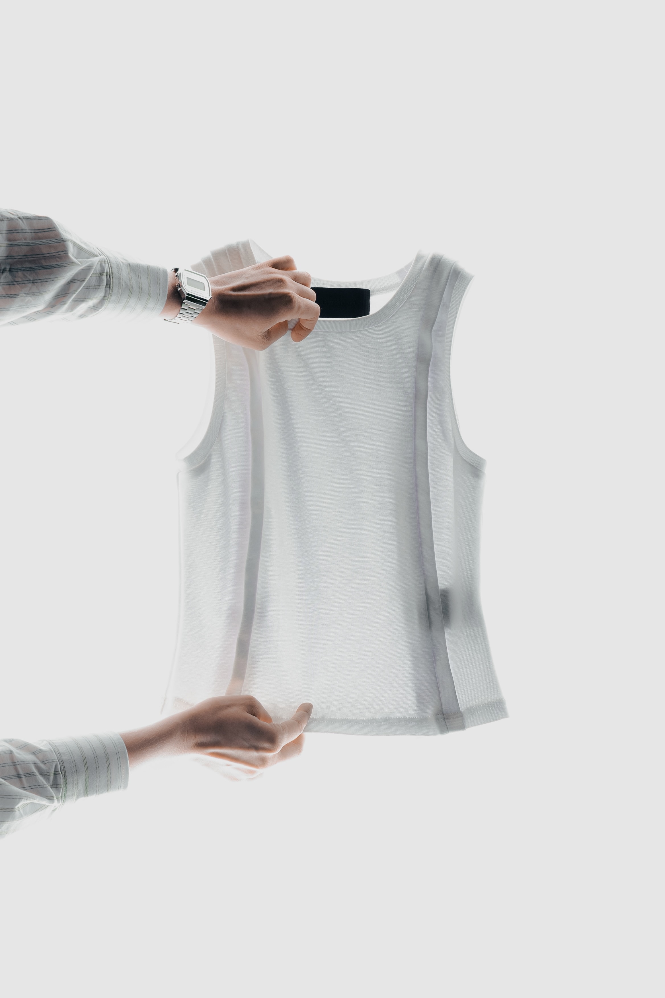 White knitted tank top with tape finishing along the edges.